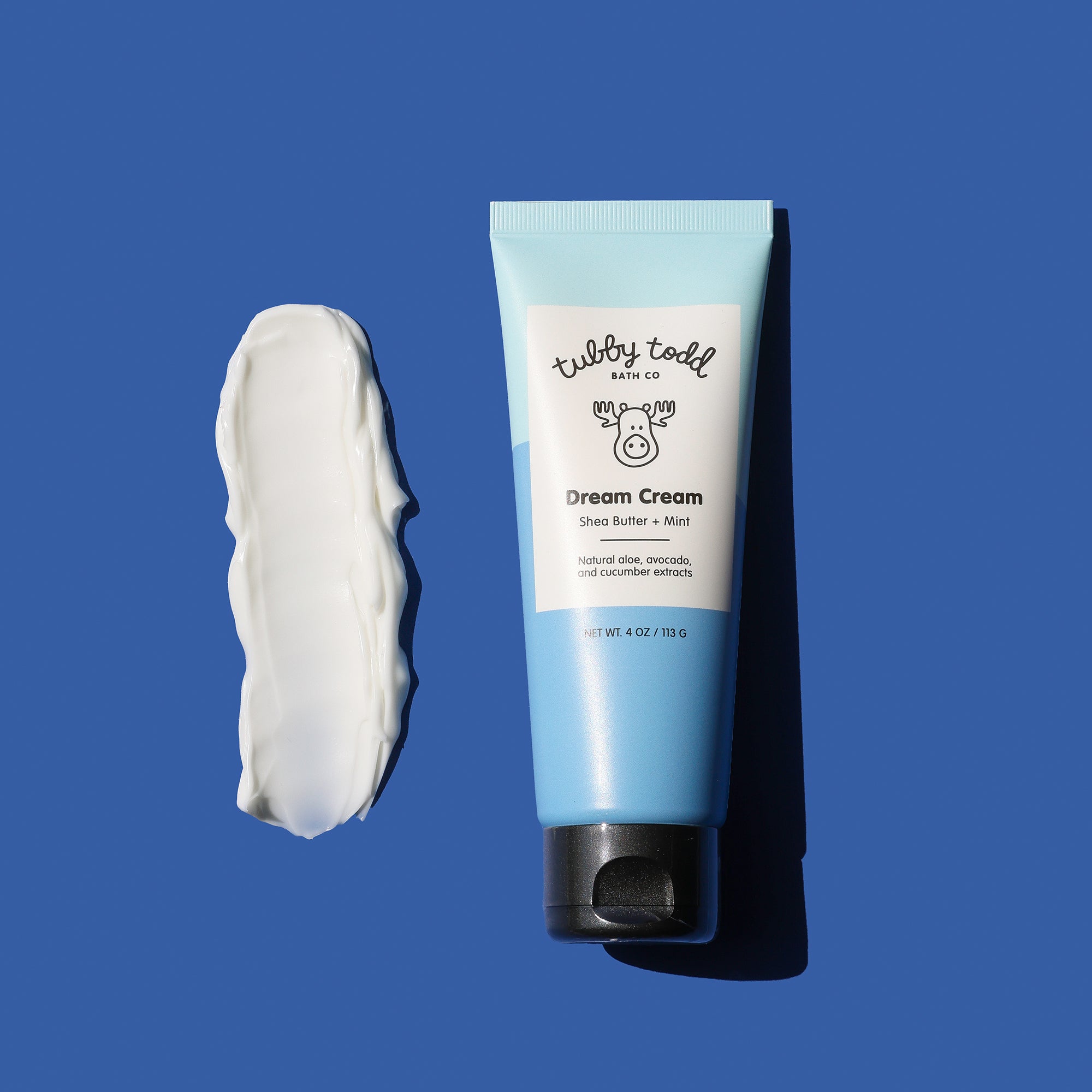 Tube of 'Tubby Todd' Dream Cream with a swatch of cream on a blue background